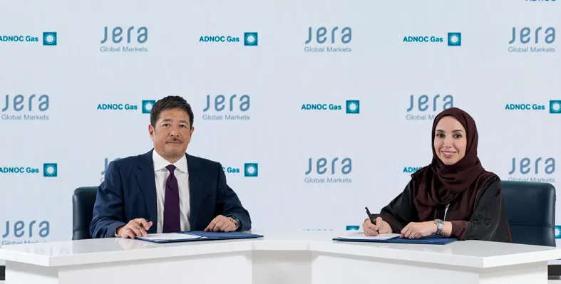 Man and woman signing agreement against JERA company logo background