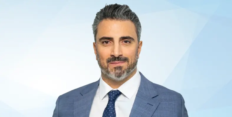 Headshot of Joseph El Bitar in blue suit and tie