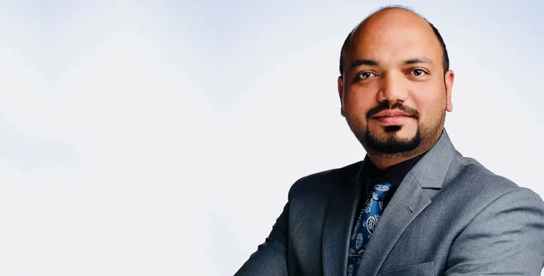 Headshot of Mohammad Tayyab in grey suit