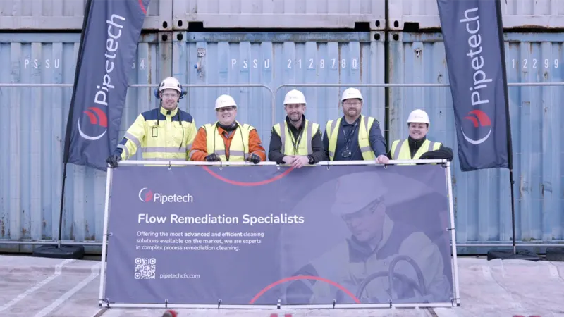 Five_people_in_hard_hats_with_company_banner