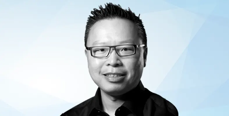 Head shot of Ed Leung against pale blue background