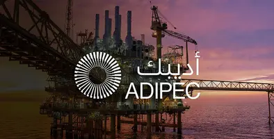 Offshore oil rig at sunset overlaid with ADIPEC logo