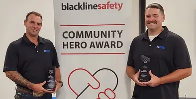 Two workers receiving an award