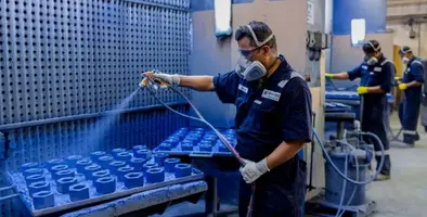Man spray painting in a factory