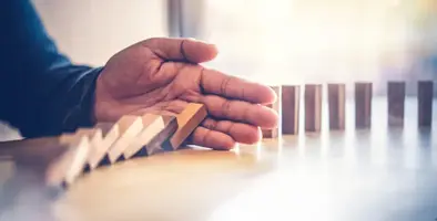 Image of dominoes falling.