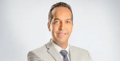 Headshot of Haytham Yehia wearing grey suit and tie