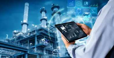 Person_holding-tablet_in_front_of_refinery
