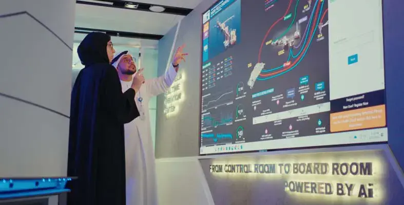 Man and woman looking at a big screen