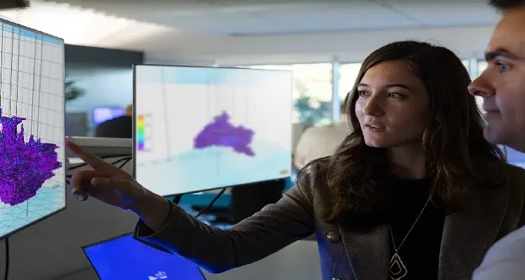 Picture of two people looking at a screen