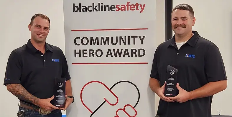 Two workers receiving an award