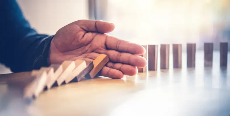 Image of dominoes falling.