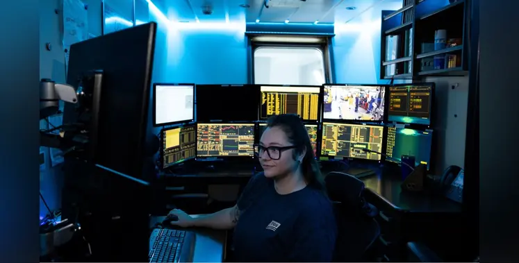 woman_surrounded_by computer_screens