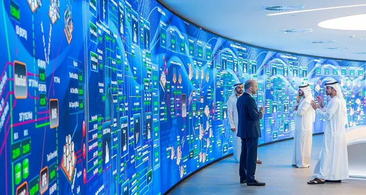 Picture of people in front of a big screen