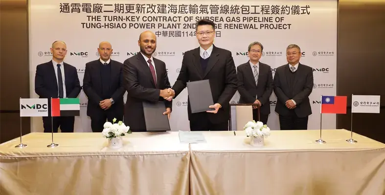 The contract is for pipeline installation, shore approach works and dredging for the Tung-Hsiao Power Plant 2nd Stage Renewal Project. (Image source: NMDC Energy) Two men shaking hands at signing ceremony with row of men in the background