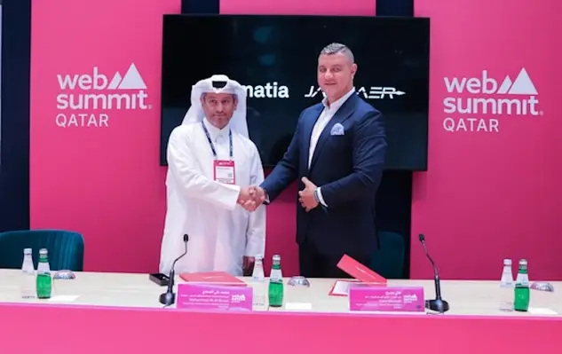 Two men shaking hands at signing ceremony